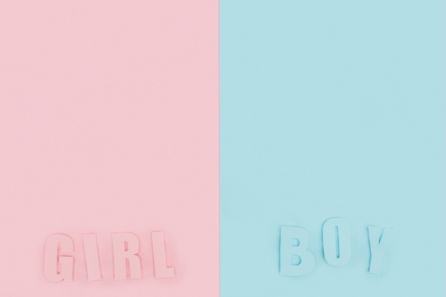 top-view-boy-girl-lettering-pink-blue-background-with-copy-space